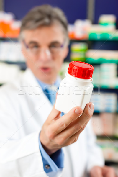 Pharmacist in pharmacy with medicament Stock photo © Kzenon