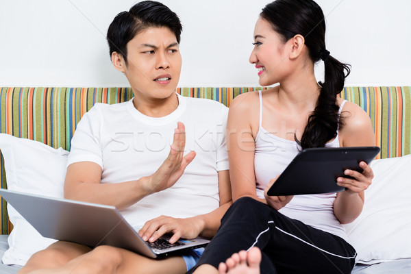 Unhappy Asian couple having issues surfing the internet Stock photo © Kzenon