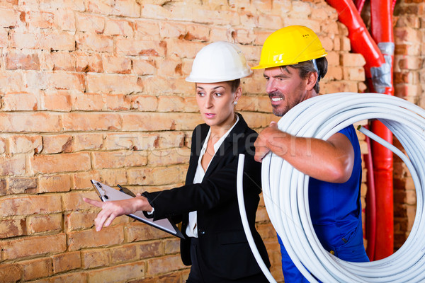 Builder and architect working on construction site Stock photo © Kzenon