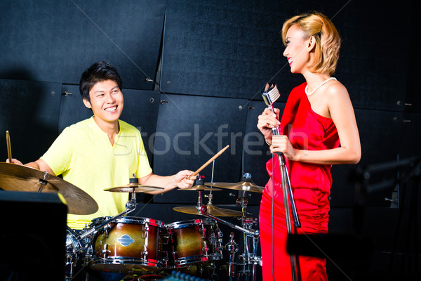 Asian professional band recording song in studio Stock photo © Kzenon