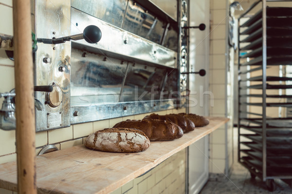 Loafs of bread waiting on shelf in bakery to be sold Stock photo © Kzenon