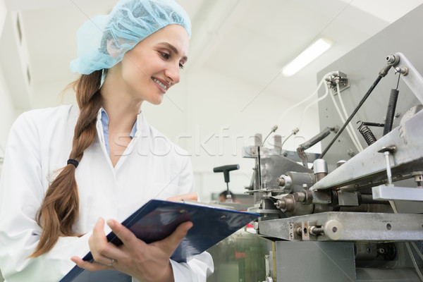 Happy woman technician checking quality of industrial machine Stock photo © Kzenon