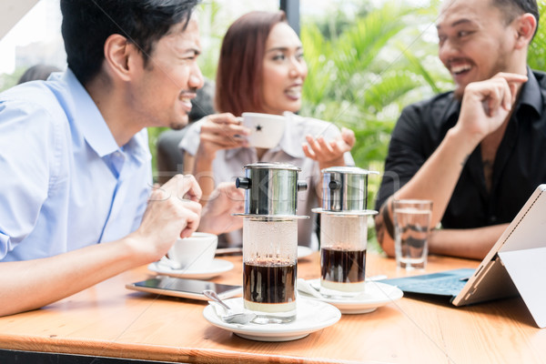 Vietnamese coffee served on the table of three friends outdoors  Stock photo © Kzenon