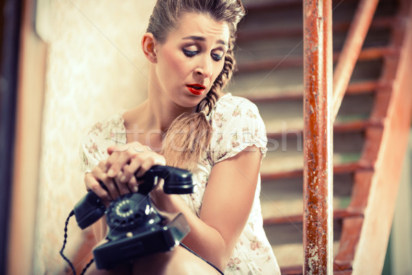 Woman sitting on the stairs and waiting for a call Stock photo © Kzenon