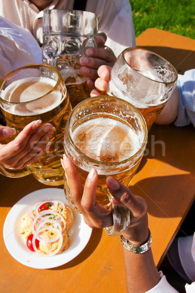 Group of four friends drinking beer Stock photo © Kzenon