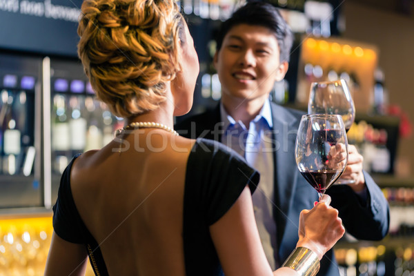 ázsiai pár iszik vörösbor pirít bor Stock fotó © Kzenon