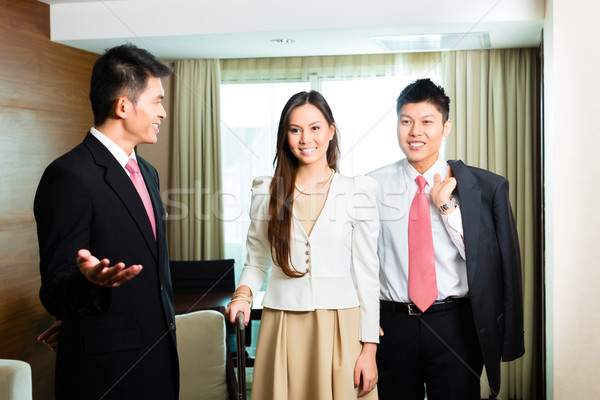 Asian Chinese hotel manager presenting suite Stock photo © Kzenon