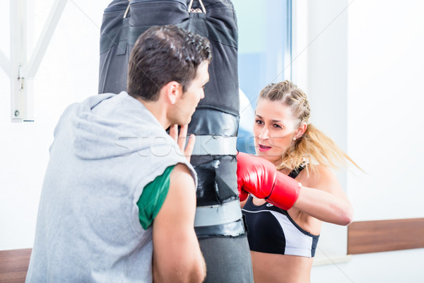 Young woman with trainer in boxing sparring Stock photo © Kzenon