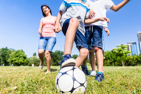 Stock photo: Family playing football or soccer in park in summer
