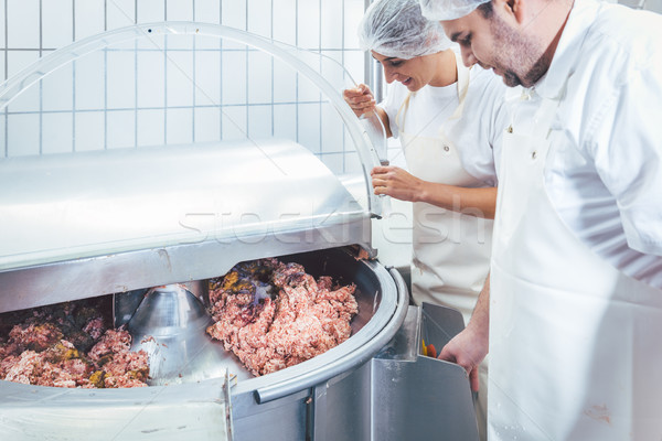Butchers in butchery processing meat Stock photo © Kzenon