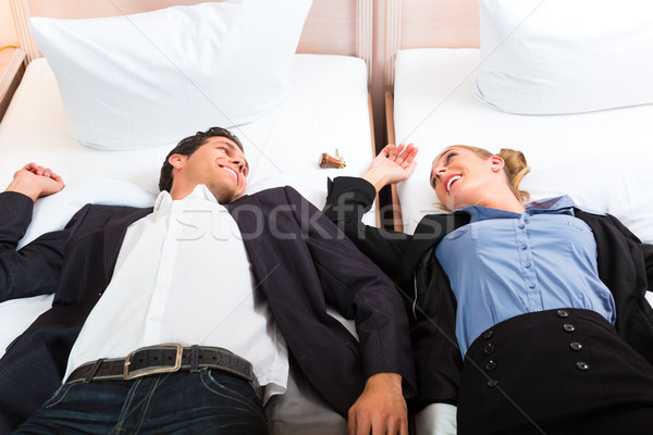 Young couple lying on bed in hotel room Stock photo © Kzenon