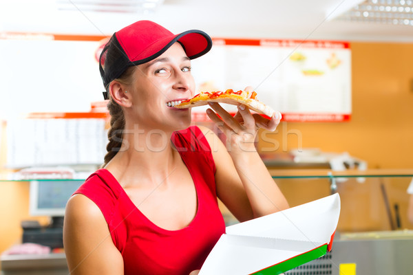 Woman eating a slice of pizza Stock photo © Kzenon