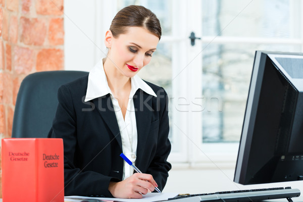 Lawyer in office making notes in a file Stock photo © Kzenon