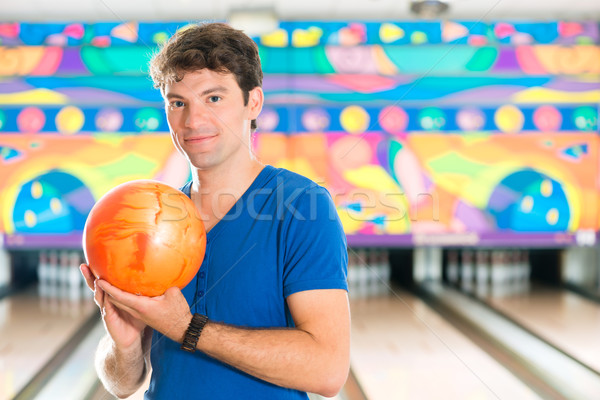 Young man bowling having fun Stock photo © Kzenon