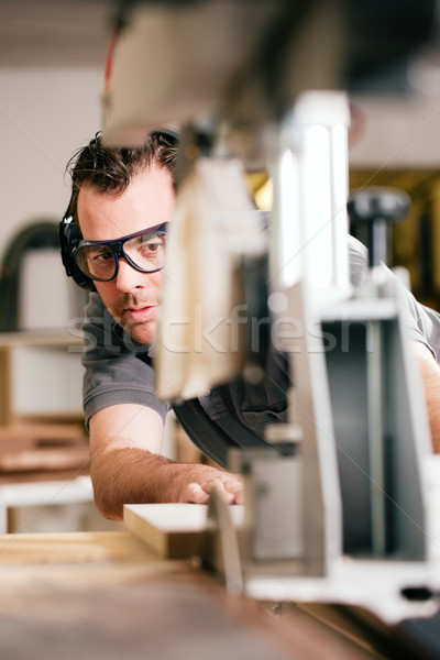 Carpenter using electric saw Stock photo © Kzenon