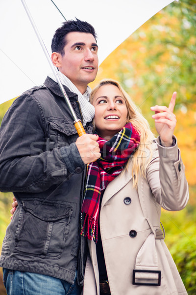 Couple enjoying fall day having walk despite the rain Stock photo © Kzenon