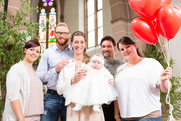 Family with baby at the altar after the christening, with red ba Stock photo © Kzenon