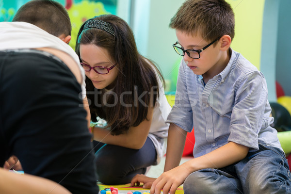 Cute pre-school boy and girl wearing eyeglasses during a creativ Stock photo © Kzenon