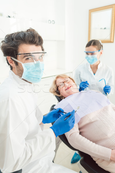 Dentist man in his surgery Stock photo © Kzenon