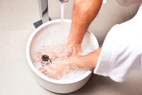 man having hydrotherapy water footbath Stock photo © Kzenon