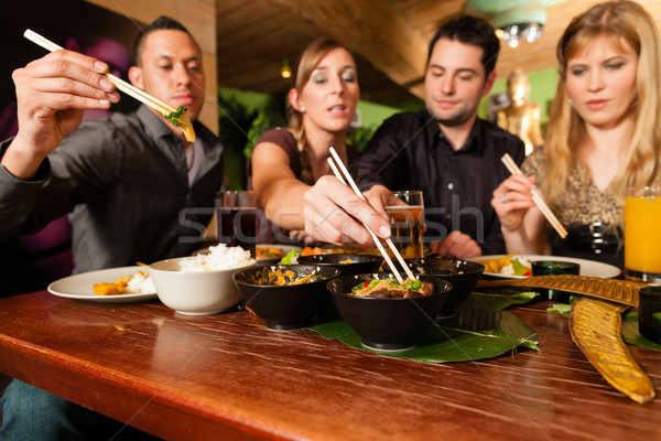 молодые люди еды тайский ресторан палочки для еды женщину Сток-фото © Kzenon