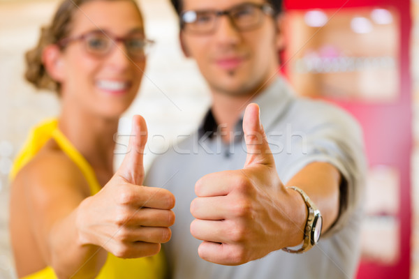 Young couple at optician with glasses Stock photo © Kzenon