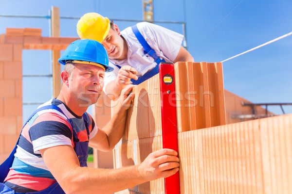 Stock photo: construction site workers checking  building shell