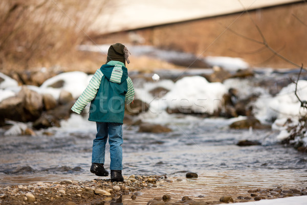 Boy with snow on river Stock photo © Kzenon