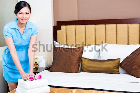 Chambermaid dusting in Asian hotel room Stock photo © Kzenon
