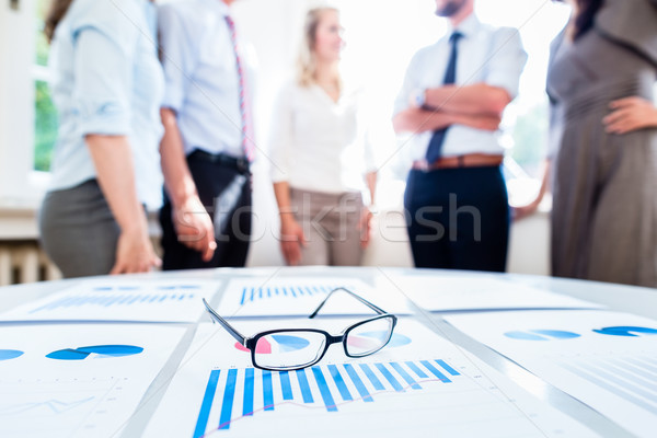 Business people in office with financial data Stock photo © Kzenon