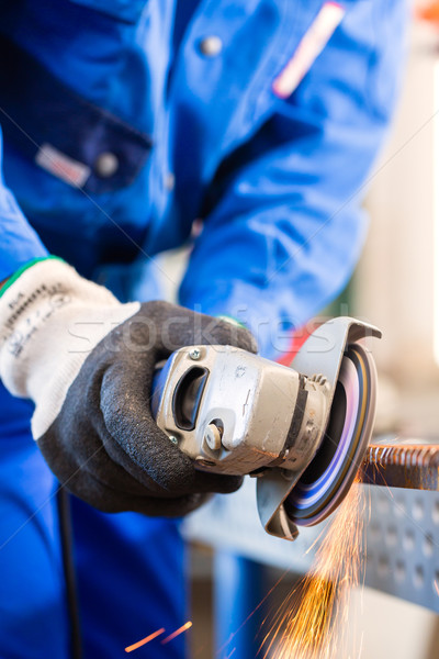 Craftsman sawing with disk grinder Stock photo © Kzenon