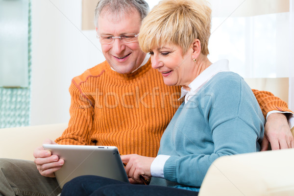 Seniors at home with tablet computer Stock photo © Kzenon