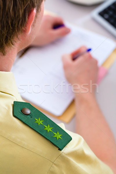 Stock photo: Police Officer working on desk in station