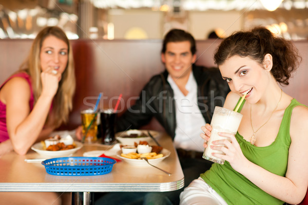 Friends in Restaurant eating fast food Stock photo © Kzenon