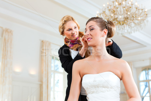 Stylist pinning up a bride's hairstyle Stock photo © Kzenon