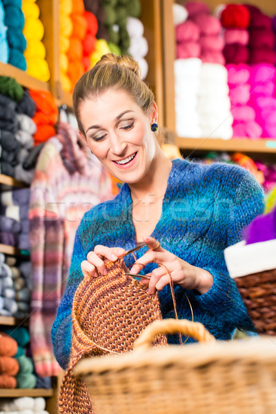 Young woman in knitting shop with circular needle Stock photo © Kzenon