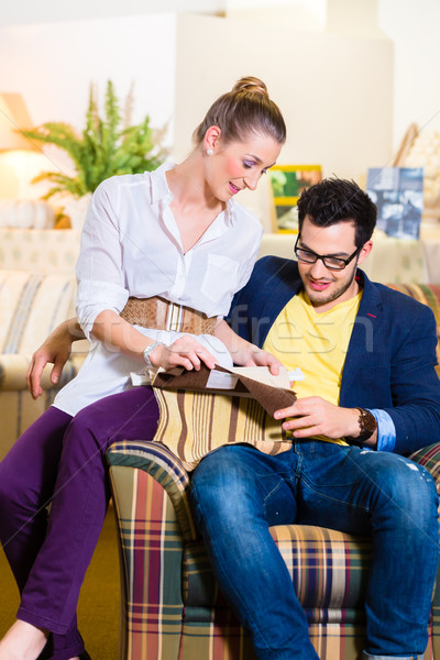 Couple picking armchair seat cover in furniture store Stock photo © Kzenon