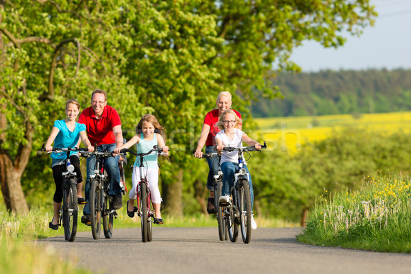 Family with kids cycling in summer with bicycles Stock photo © Kzenon