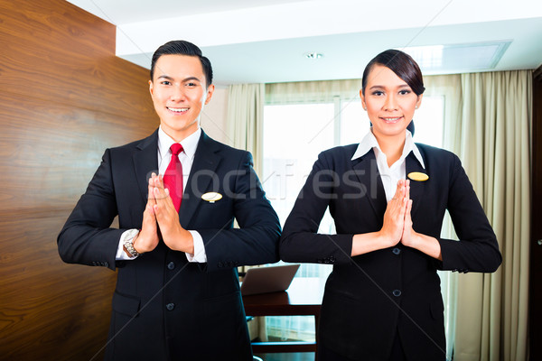 Staff greeting guests in Asian hotel Stock photo © Kzenon