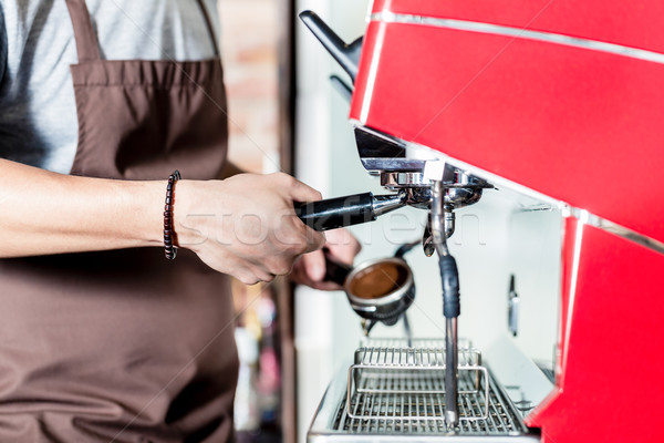 Barista preparing coffee on portafilter machine in cafe Stock photo © Kzenon