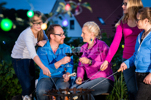 Stock photo: Family grilling bread on a stick at barbeque