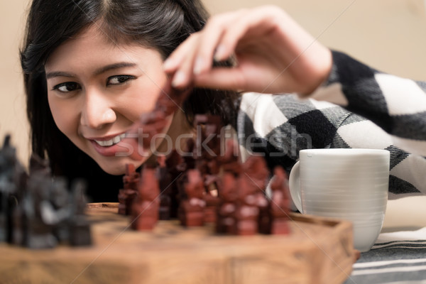 Indonesian woman playing chess setting figure Stock photo © Kzenon