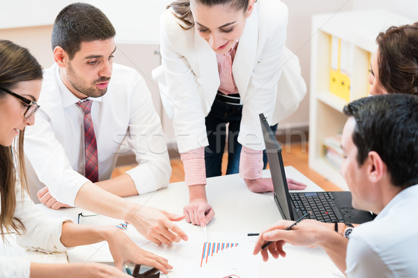 Business team analyzing data and discussing strategy Stock photo © Kzenon