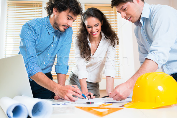 Stock photo: Civil engineers and architects talking about ground plot