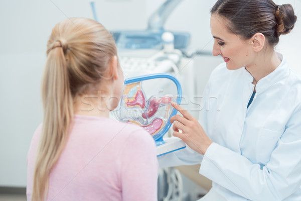 Childless woman in fertility clinic talking to doctor Stock photo © Kzenon