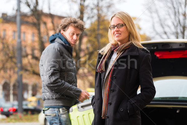 Young woman in front of taxi Stock photo © Kzenon