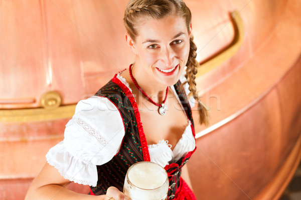 Woman with beer glass in brewery Stock photo © Kzenon