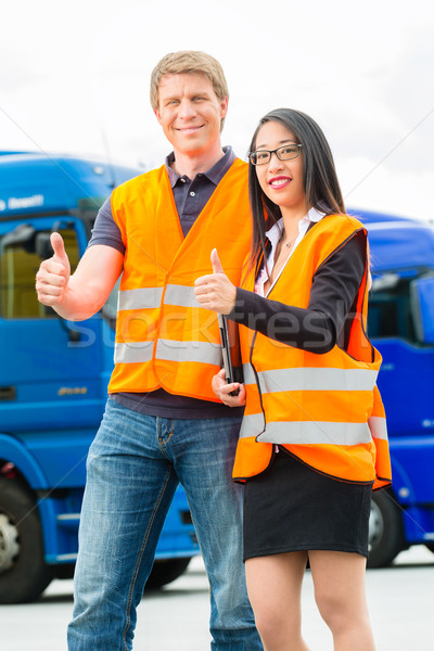 Stock photo: Forwarder in front of trucks on a depot