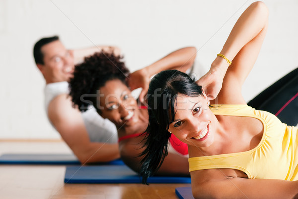 Siłowni fitness grupy trzy osoby Zdjęcia stock © Kzenon