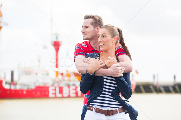 Couple hugging at Harbor pier looking at ships Stock photo © Kzenon